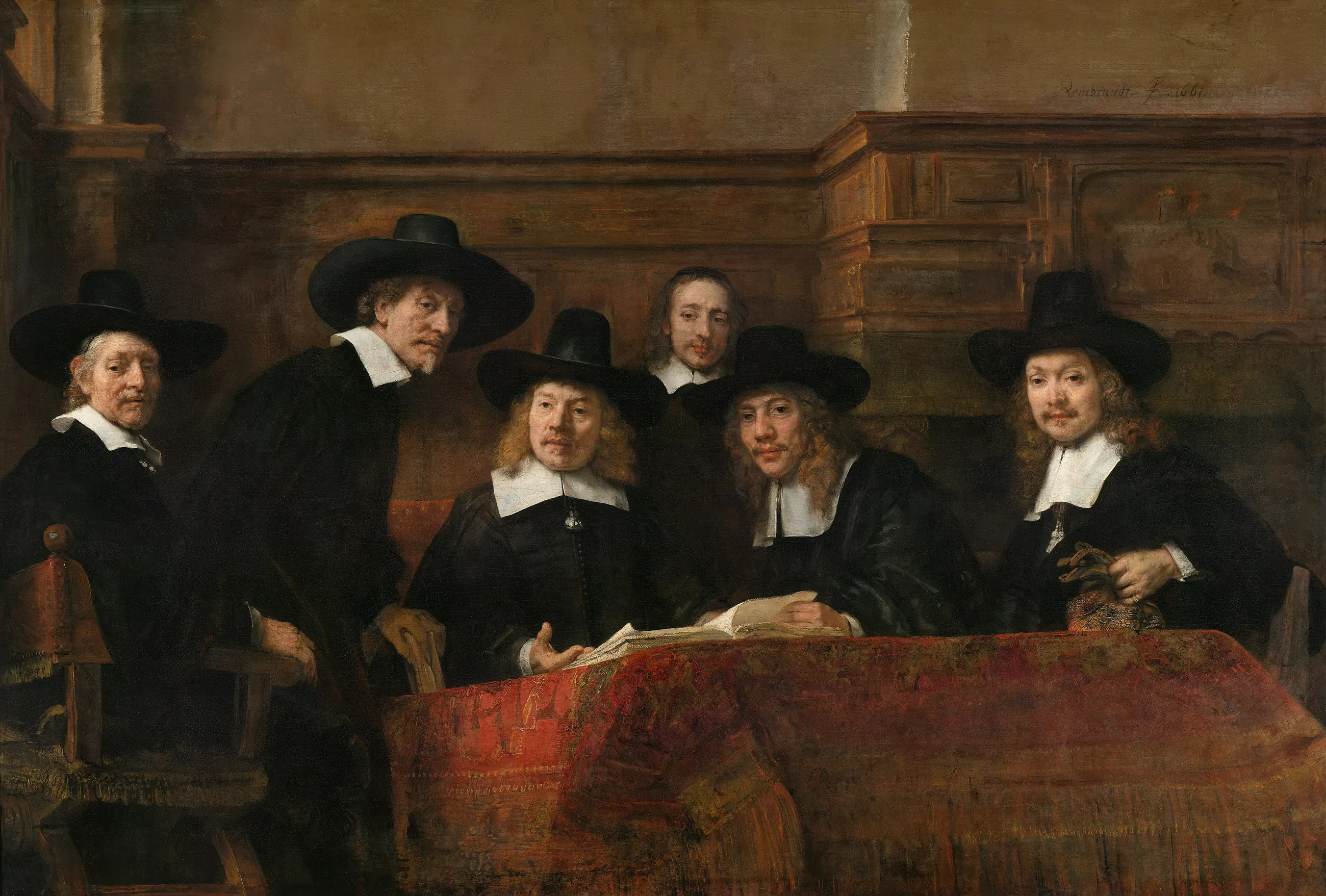 Rembrandt’s The Syndics: five cloth-guild officials in black hats and white collars look up from a ledger on a red carpeted table, as if interrupted mid-inspection.